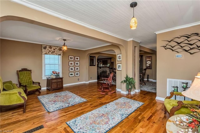 2606 Boone Trl, North Wilkesboro, NC 28659 - living area featuring arched walkways, wood finished floors, ornamental molding, and baseboards