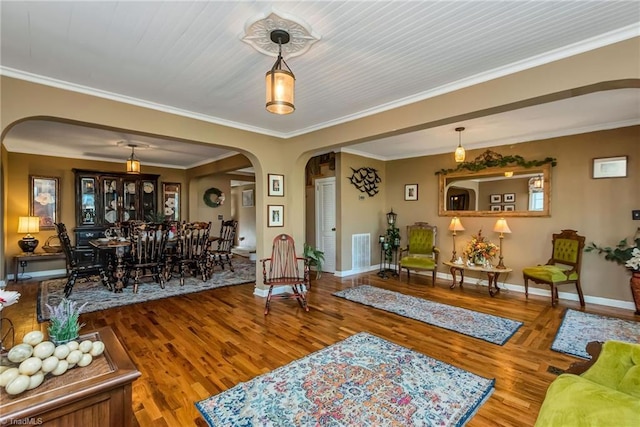 2606 Boone Trl, North Wilkesboro, NC 28659 - living area featuring arched walkways, wood finished floors, baseboards, and crown molding