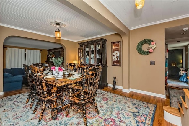 2606 Boone Trl, North Wilkesboro, NC 28659 - dining space featuring arched walkways, wood finished floors, baseboards, and ornamental molding