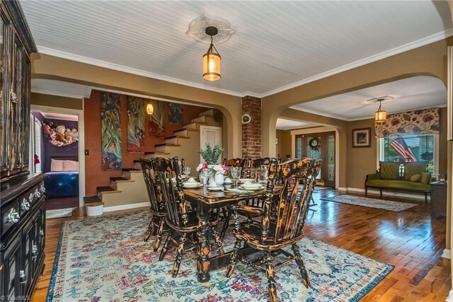 2606 Boone Trl, North Wilkesboro, NC 28659 - dining area with arched walkways, stairs, wood finished floors, ornamental molding, and baseboards