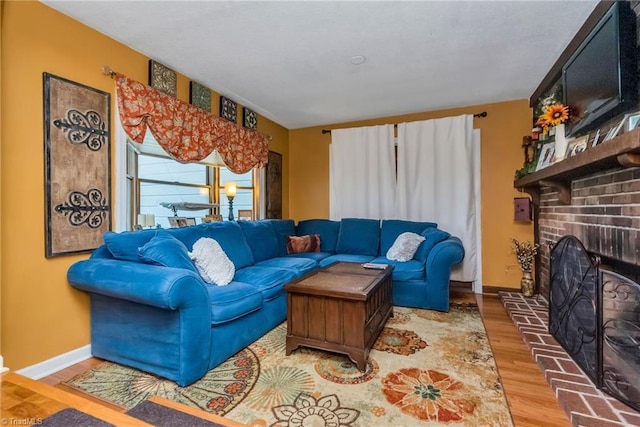 2606 Boone Trl, North Wilkesboro, NC 28659 - living room featuring wood finished floors, a fireplace, and baseboards