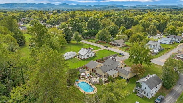 2606 Boone Trl, North Wilkesboro, NC 28659 - aerial perspective of suburban area with a heavily wooded area, mountains, and a pool