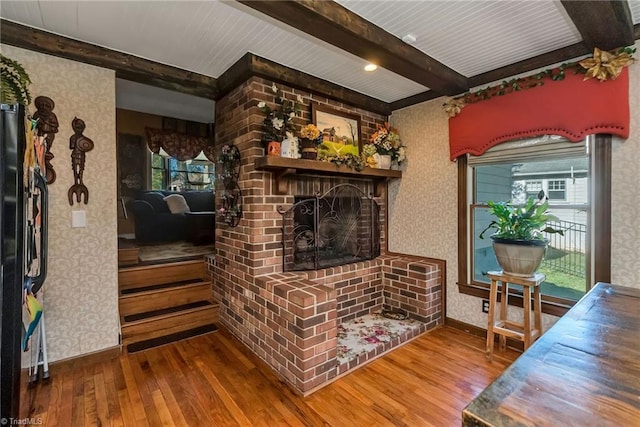 2606 Boone Trl, North Wilkesboro, NC 28659 - living area featuring wallpapered walls, beam ceiling, hardwood / wood-style floors, baseboards, and a fireplace