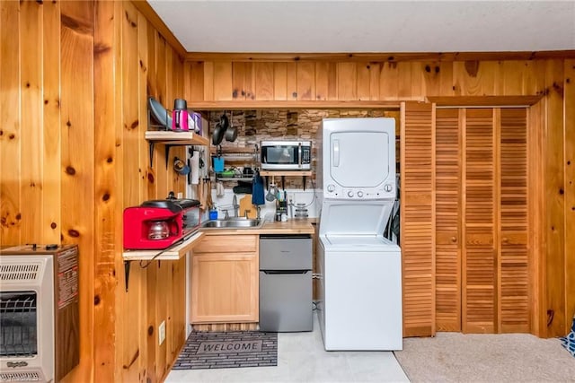 2606 Boone Trl, North Wilkesboro, NC 28659 - laundry room with stacked washing machine and dryer, heating unit, a sink, and wooden walls