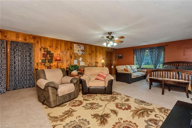 2606 Boone Trl, North Wilkesboro, NC 28659 - living area featuring carpet floors, ceiling fan, and wooden walls
