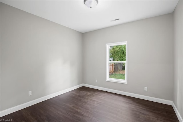 spare room with dark hardwood / wood-style flooring