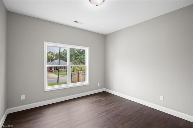 spare room with dark hardwood / wood-style flooring