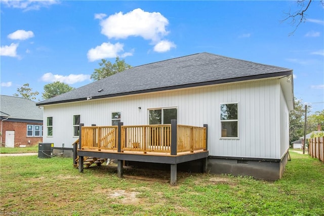 back of house featuring a deck, a yard, and central air condition unit