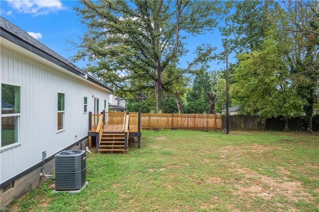 view of yard with central AC unit and a deck