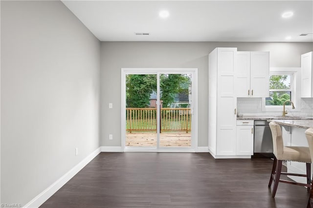 kitchen with plenty of natural light and white cabinetry