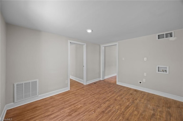 unfurnished room with wood finished floors, baseboards, and recessed lighting