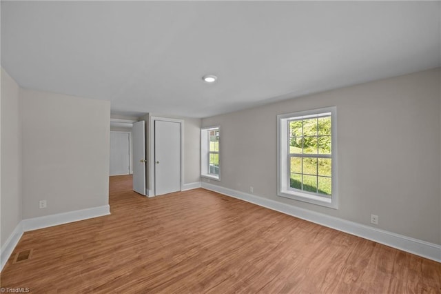 unfurnished room featuring baseboards and wood finished floors