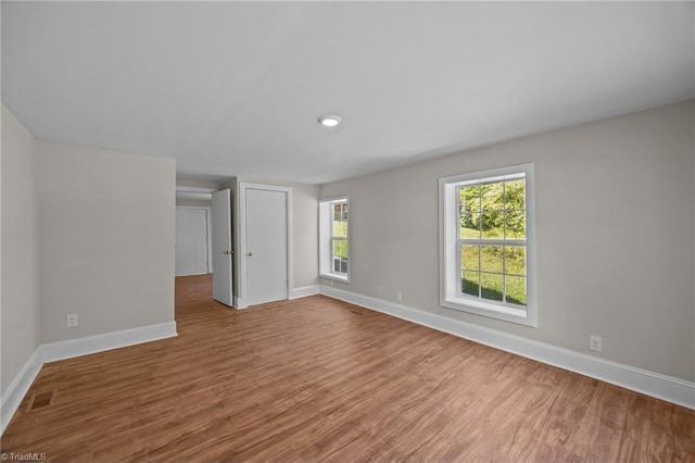 empty room with baseboards and wood finished floors