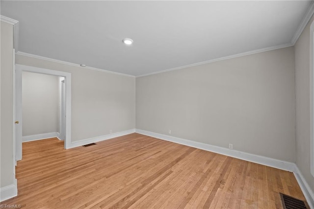 spare room featuring baseboards, light wood-style floors, ornamental molding, and recessed lighting