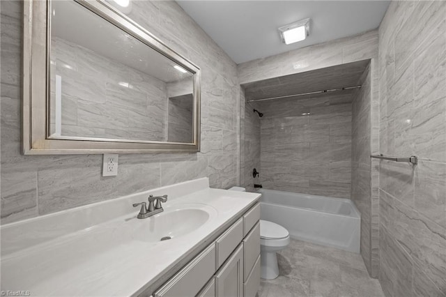 full bathroom with toilet, vanity, shower / washtub combination, and tile walls