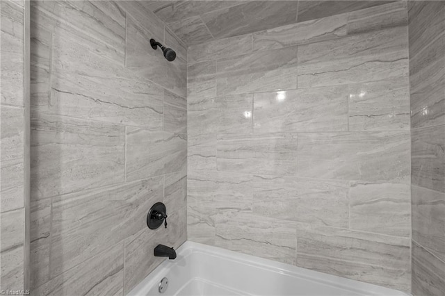 bathroom view of bathing tub / shower combination