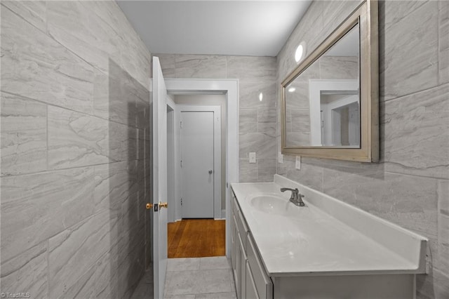 bathroom featuring tile walls and vanity