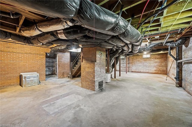 below grade area with stairs and brick wall