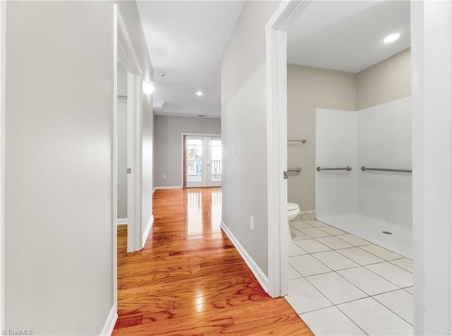 hall with french doors and light hardwood / wood-style floors