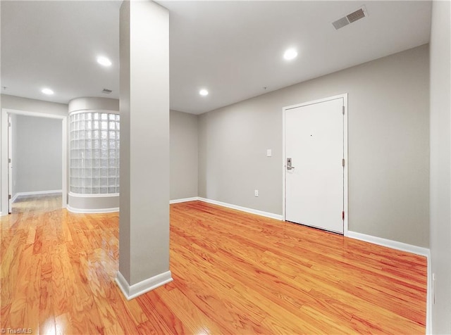 basement with light hardwood / wood-style flooring