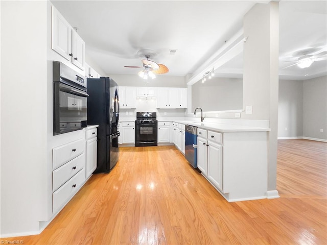 kitchen with white cabinetry, sink, ceiling fan, black appliances, and light wood-type flooring