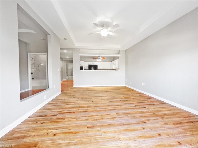 unfurnished living room with ceiling fan and light hardwood / wood-style flooring