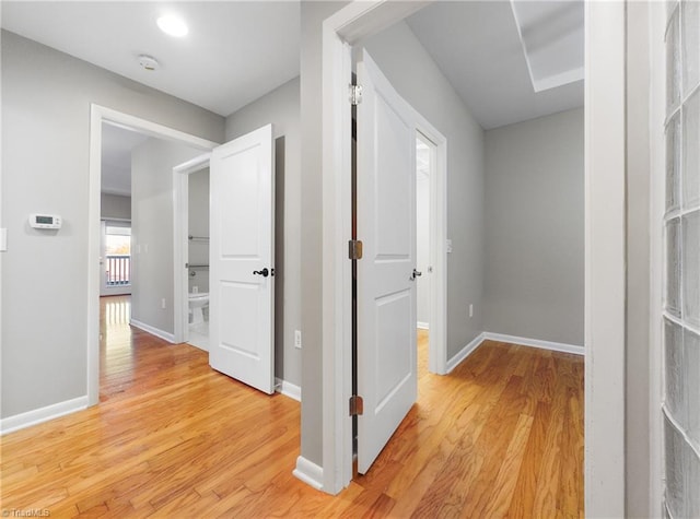 hallway with light hardwood / wood-style floors