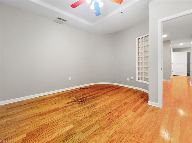 unfurnished room with light wood-type flooring and ceiling fan