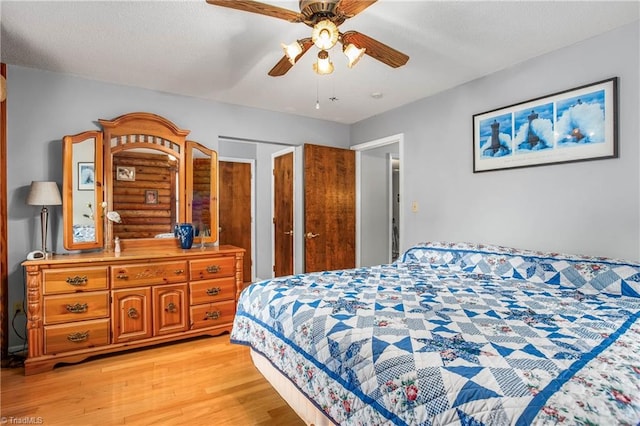 bedroom with light hardwood / wood-style flooring and ceiling fan