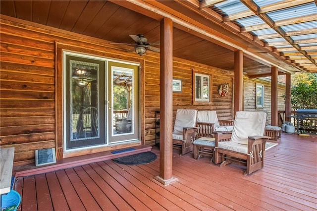 wooden deck with a porch and ceiling fan