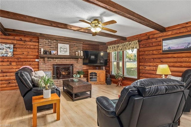 living room with a textured ceiling, ceiling fan, beam ceiling, light wood-type flooring, and log walls