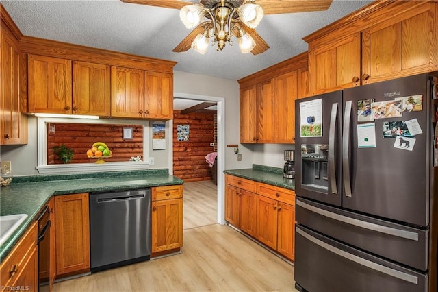 kitchen with light wood-type flooring, appliances with stainless steel finishes, a textured ceiling, and ceiling fan