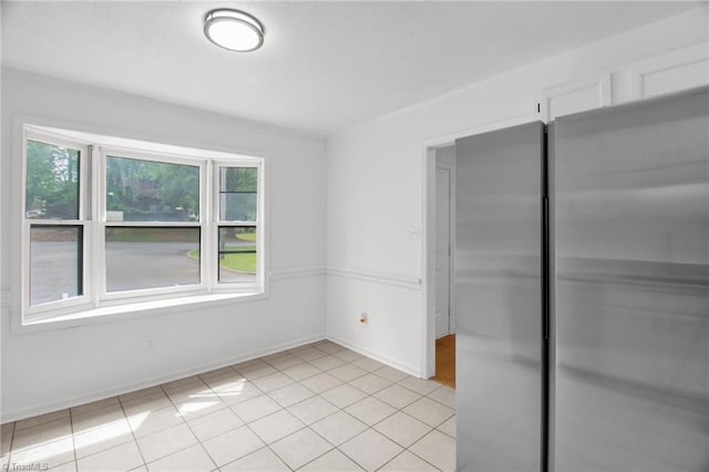 3114 Rockingham Rd, High Point, NC 27265 - unfurnished bedroom featuring freestanding refrigerator, light tile patterned flooring, and a closet
