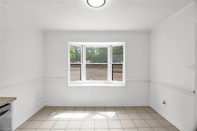 3114 Rockingham Rd, High Point, NC 27265 - spare room featuring light tile patterned flooring and a textured ceiling