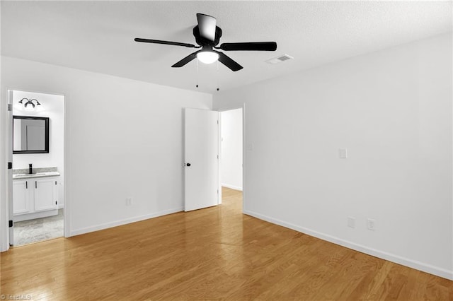 3114 Rockingham Rd, High Point, NC 27265 - unfurnished bedroom featuring light wood-style floors, ensuite bathroom, and ceiling fan