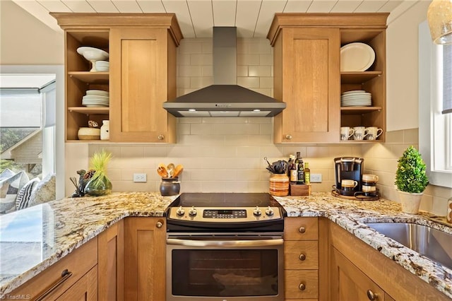 kitchen with tasteful backsplash, light stone countertops, stainless steel range with electric cooktop, and wall chimney range hood