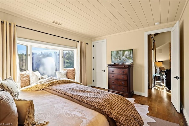 bedroom featuring dark hardwood / wood-style floors, wood ceiling, and ornamental molding