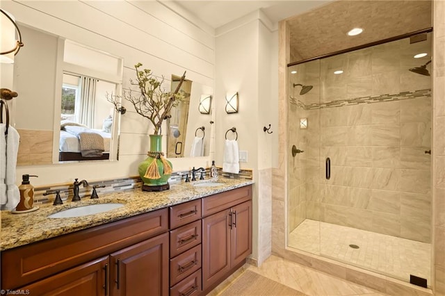 bathroom featuring wooden walls, a shower with door, vanity, and tile patterned flooring