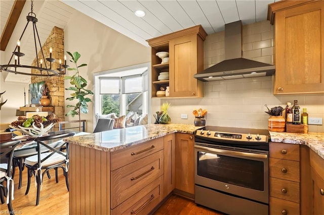 kitchen featuring wall chimney range hood, lofted ceiling with beams, pendant lighting, light hardwood / wood-style floors, and electric stove