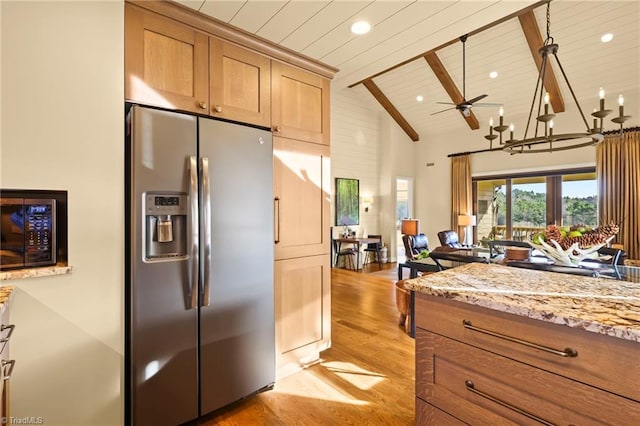 kitchen featuring lofted ceiling with beams, ceiling fan with notable chandelier, stainless steel fridge, light hardwood / wood-style floors, and wood ceiling