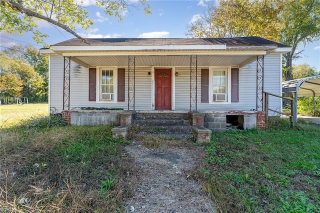 view of front of property with a porch and a carport