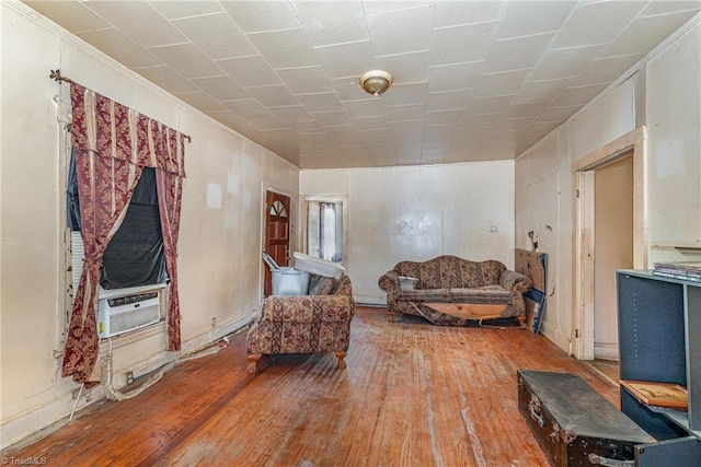 living area with wood-type flooring and cooling unit