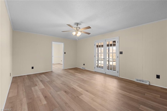 unfurnished room with ceiling fan, light hardwood / wood-style floors, and a textured ceiling