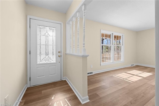 foyer entrance with light hardwood / wood-style flooring