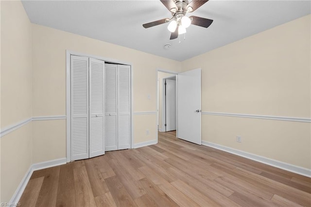 unfurnished bedroom featuring a closet, ceiling fan, and light wood-type flooring