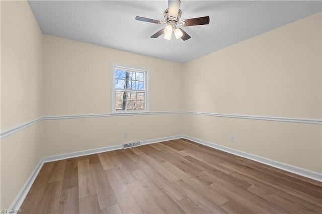 spare room featuring ceiling fan and light wood-type flooring