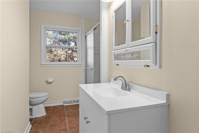 bathroom with vanity, walk in shower, tile patterned floors, and toilet