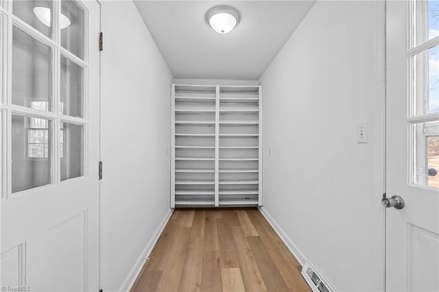 spacious closet with light hardwood / wood-style floors