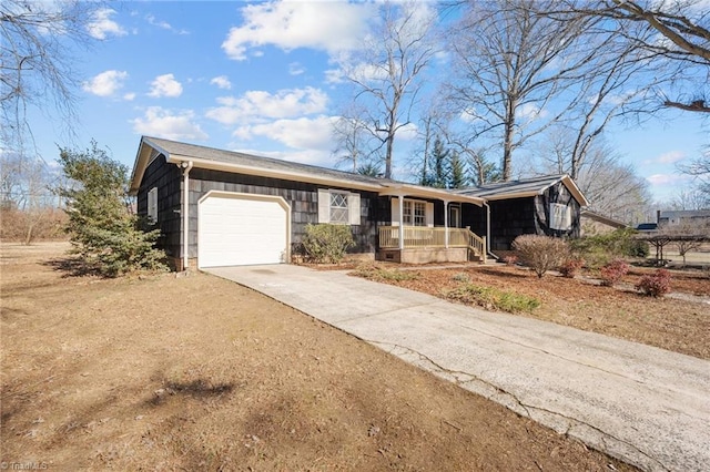 ranch-style home with a garage and a porch