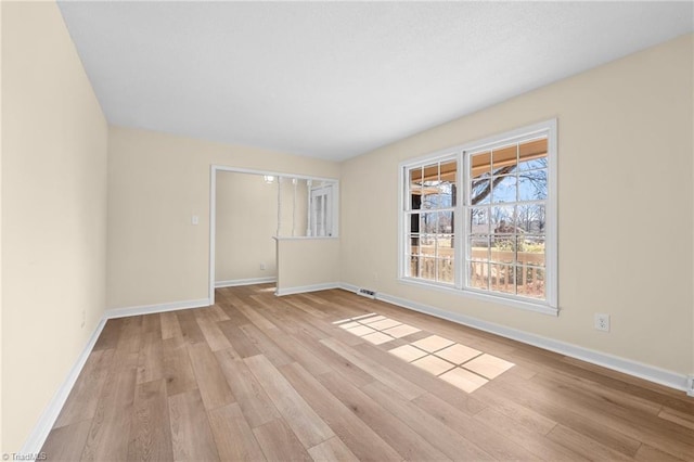 spare room with light hardwood / wood-style flooring